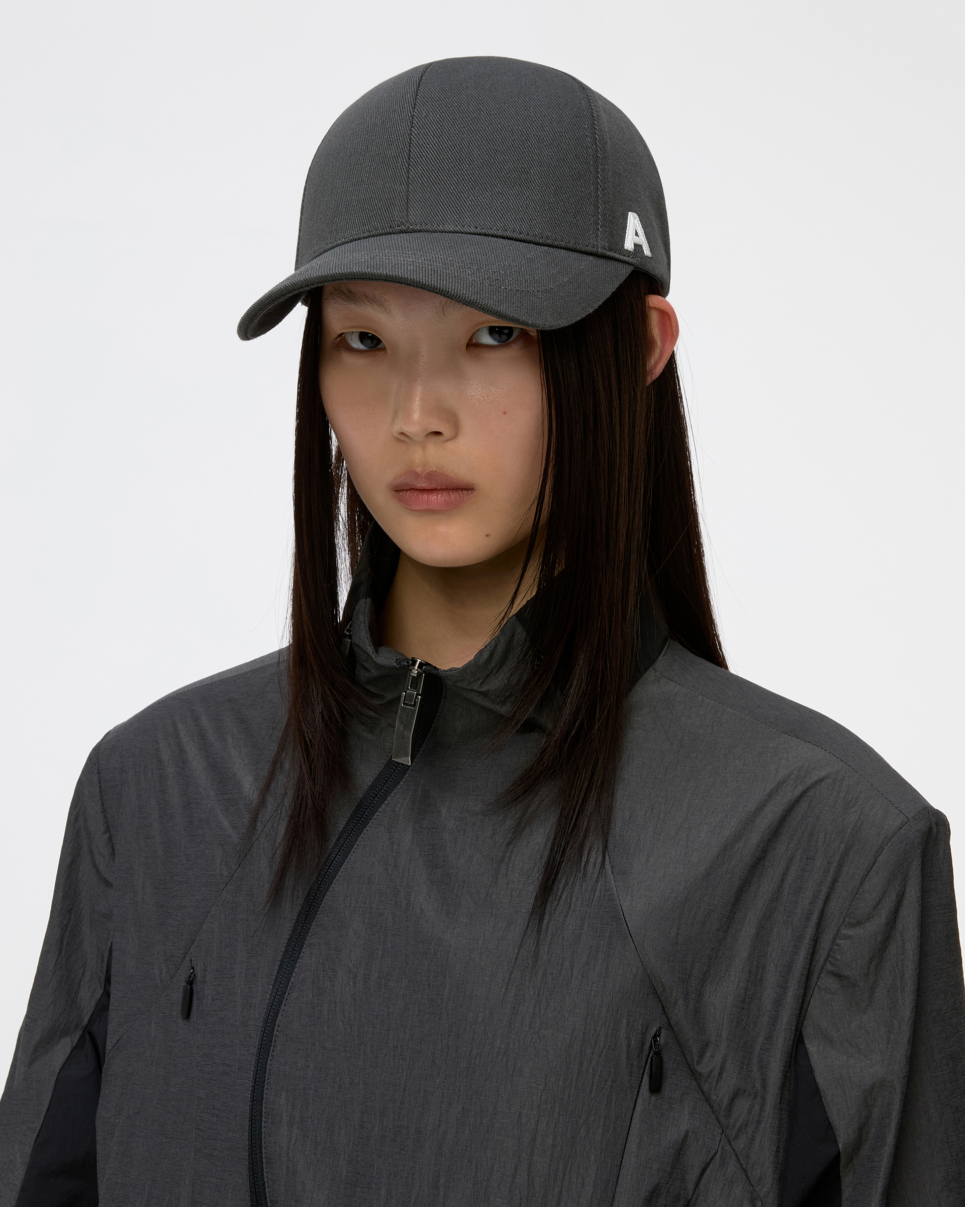ADER A Cap in Charcoal — model wearing, front view